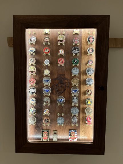 Challenge coin display case mounted on the wall with a French cleat