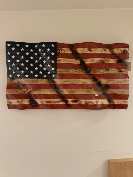 Wavy wooden American flag hung on a wall